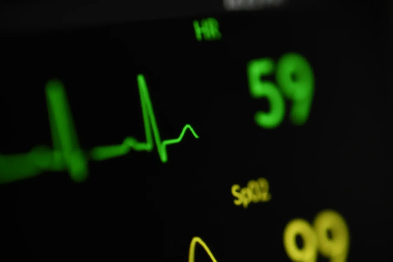 Extreme close up of digital blood pressure monitor displaying blood pressure readings.