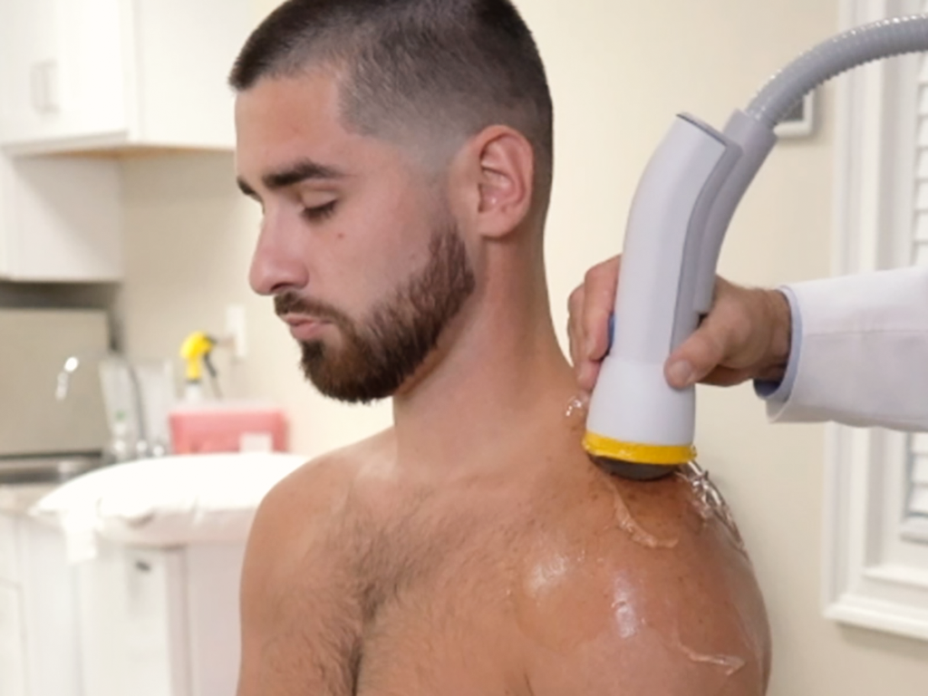SoftWave Therapy being used on patient's shoulder