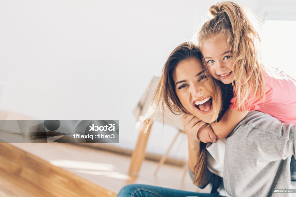Young woman and small girl having a great time together