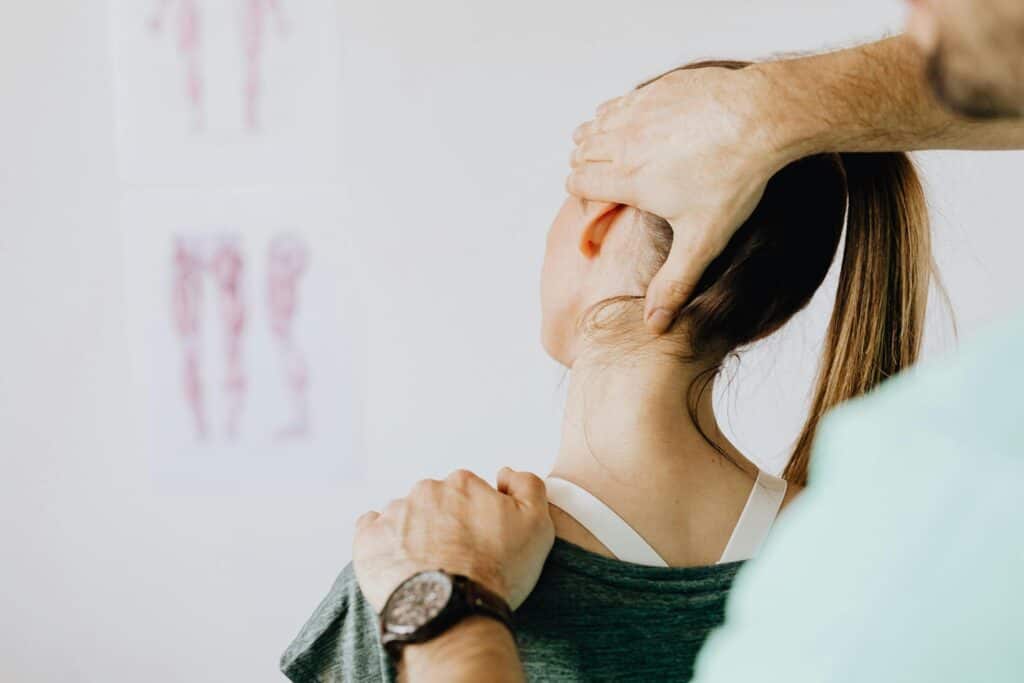 woman getting neck examined for atlas adjustment
