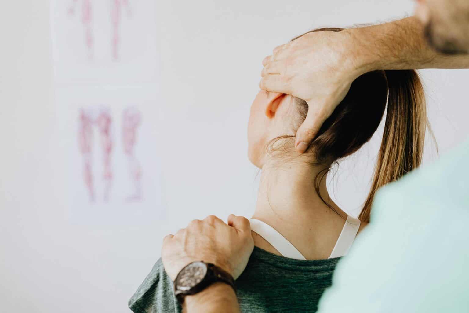 woman getting neck examined for atlas adjustment