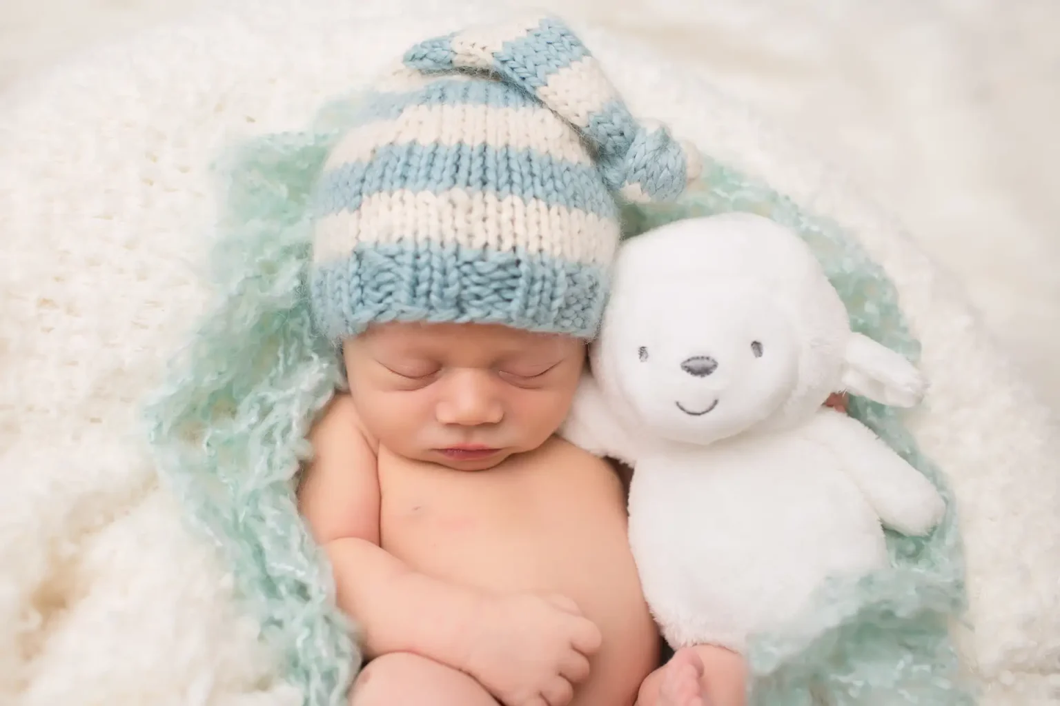 Infant child sleeping with stuffed animal
