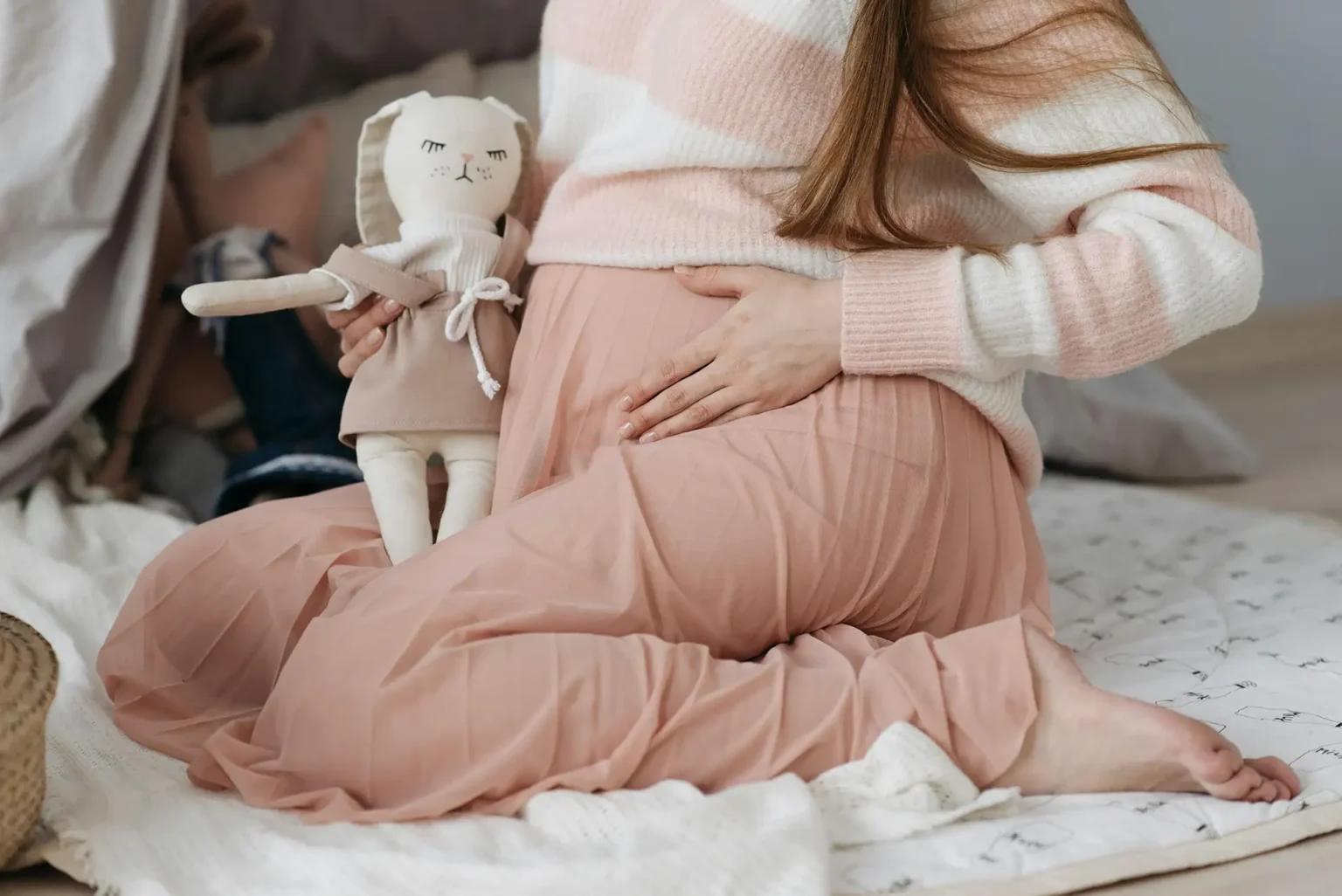 Pregnant woman with bunny stuffed animal