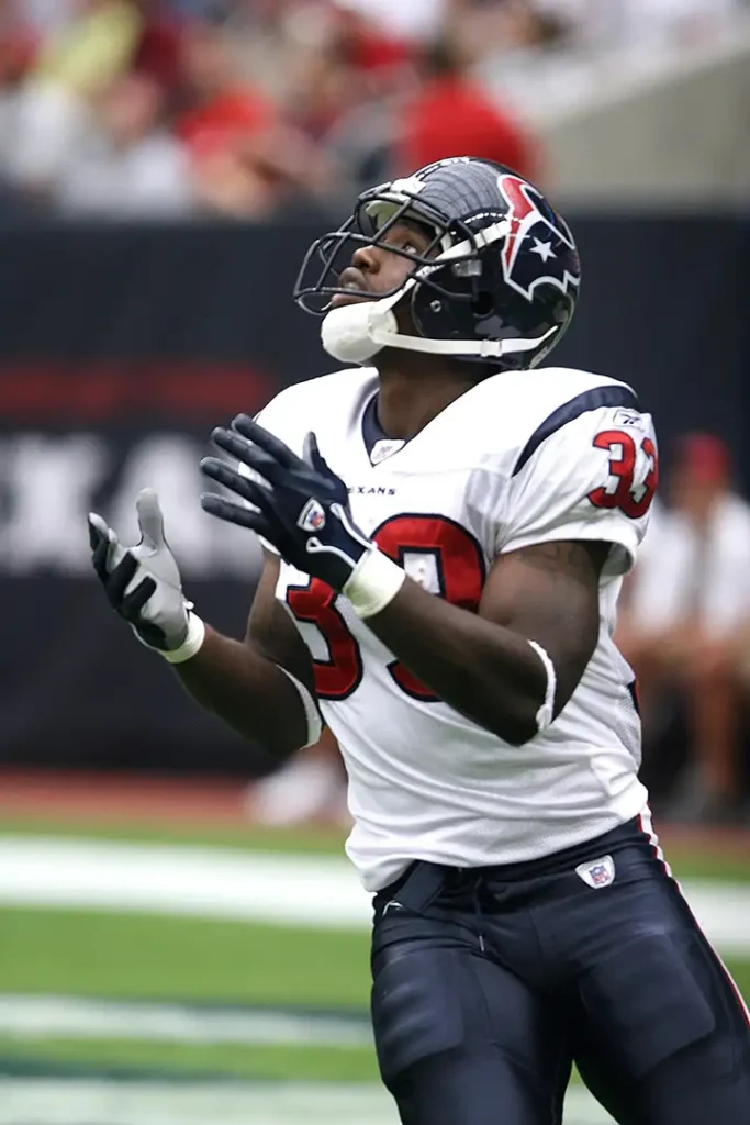 Football player in uniform concentrating during a game on the field